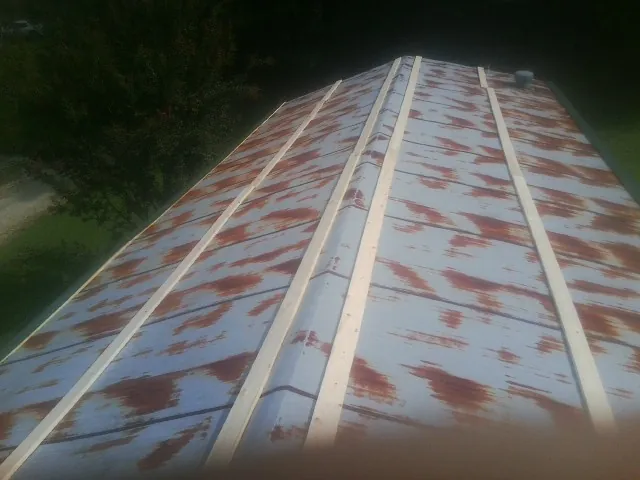 Rusted metal roof panels with new wood purlins before replacement — Storm Damage Roof Repair in Emmitsburg by Roofing Brothers