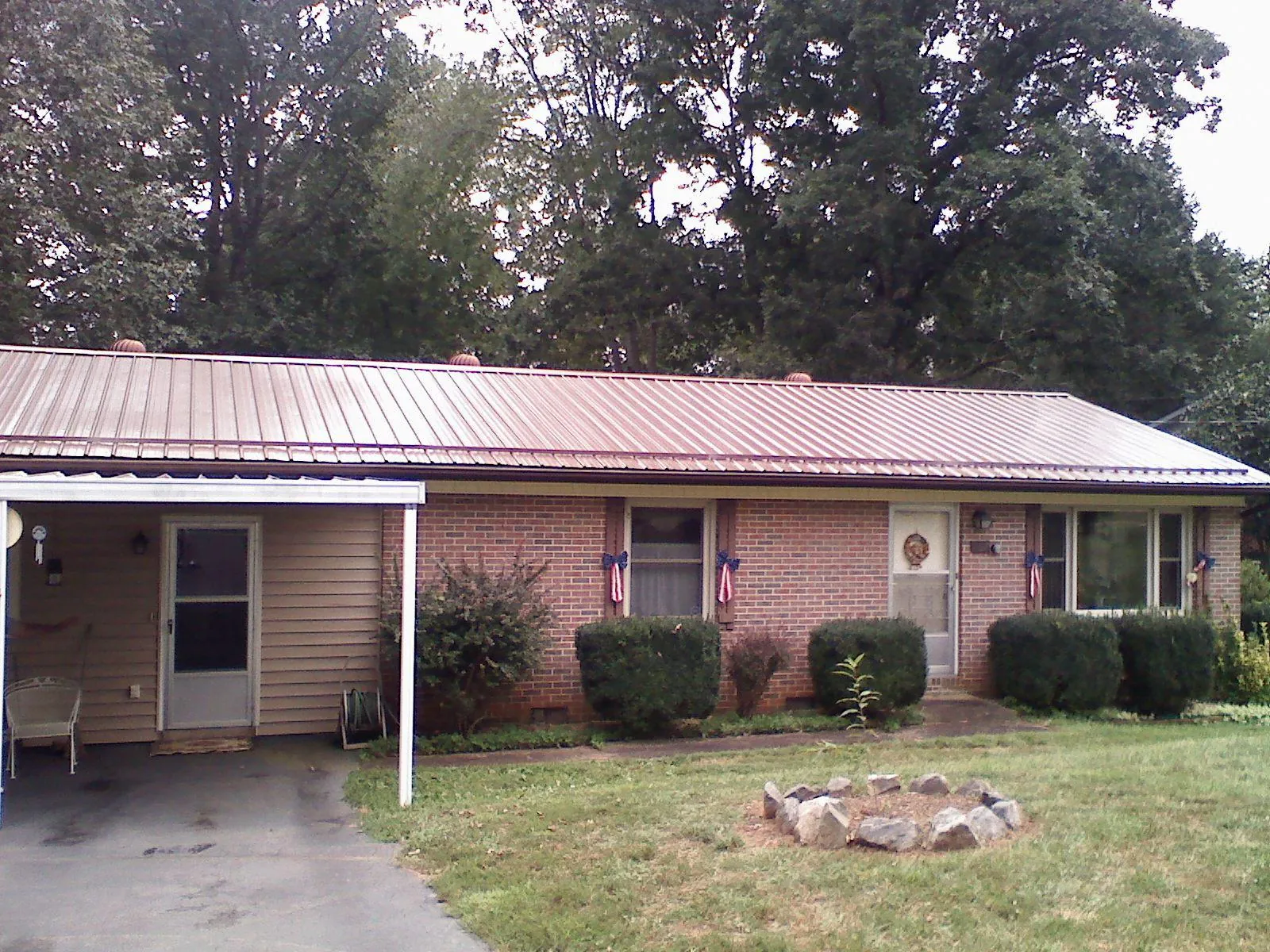 Bronze metal roof and carport on a brick ranch home — Roof Repair work by our crew in Emmitsburg