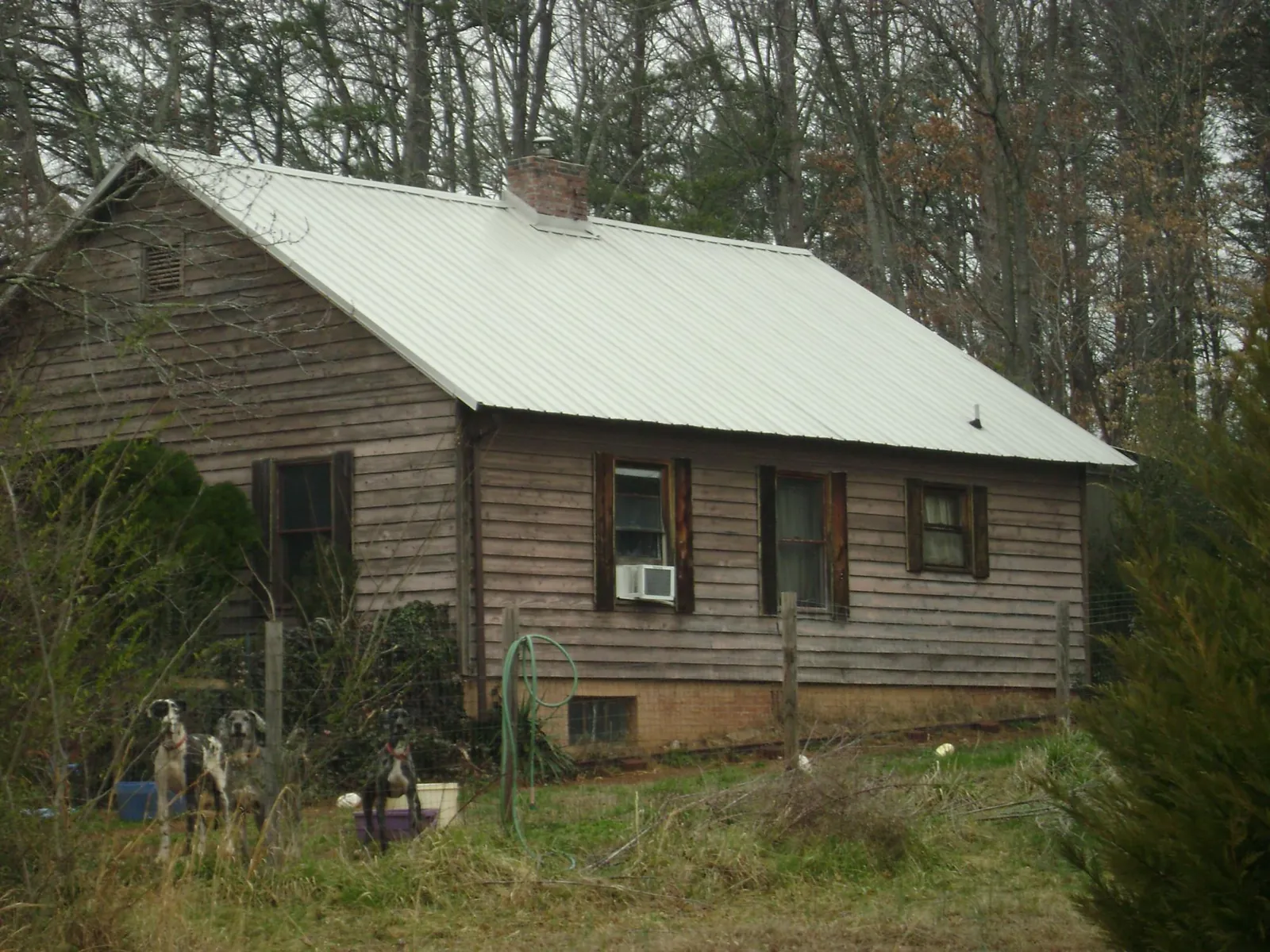 White metal roof on an old wood sided farmhouse, from a Metal Roof Installation job in Emmitsburg